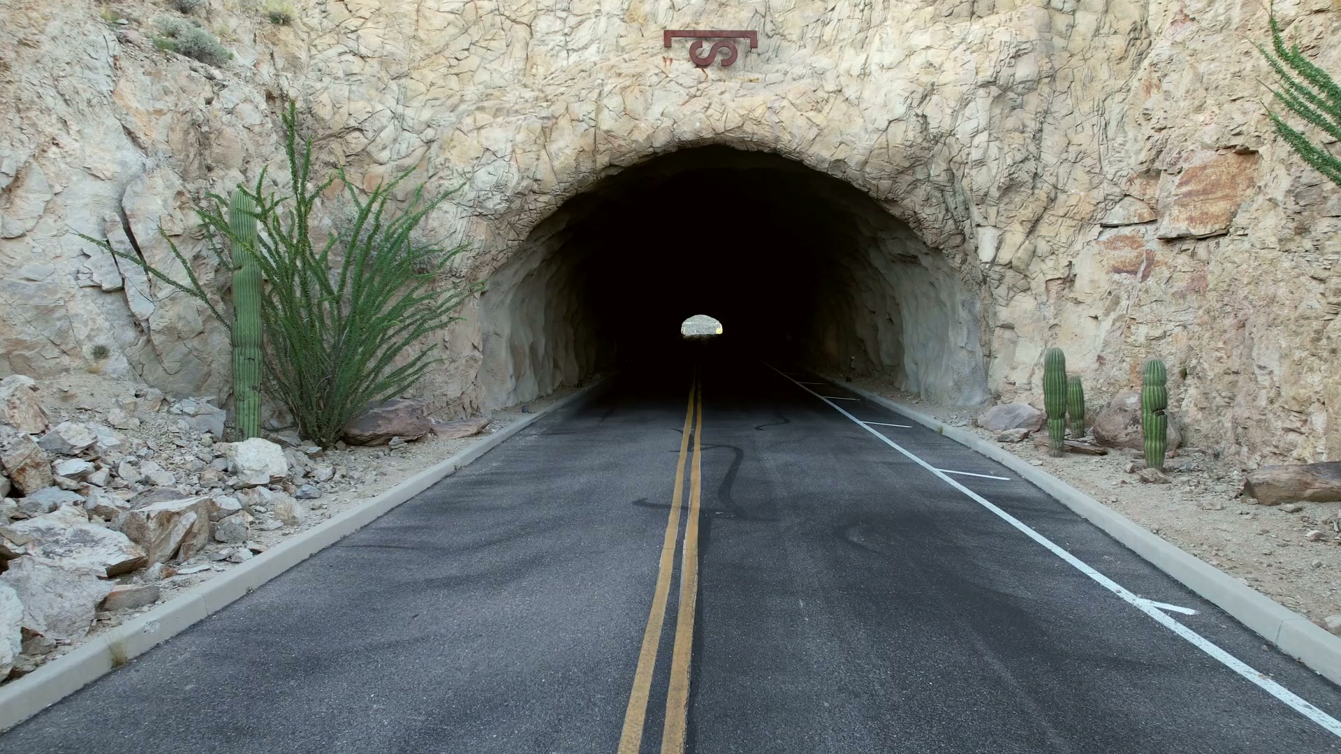 The rock tunnel that is the only road into Saguaro Ranch