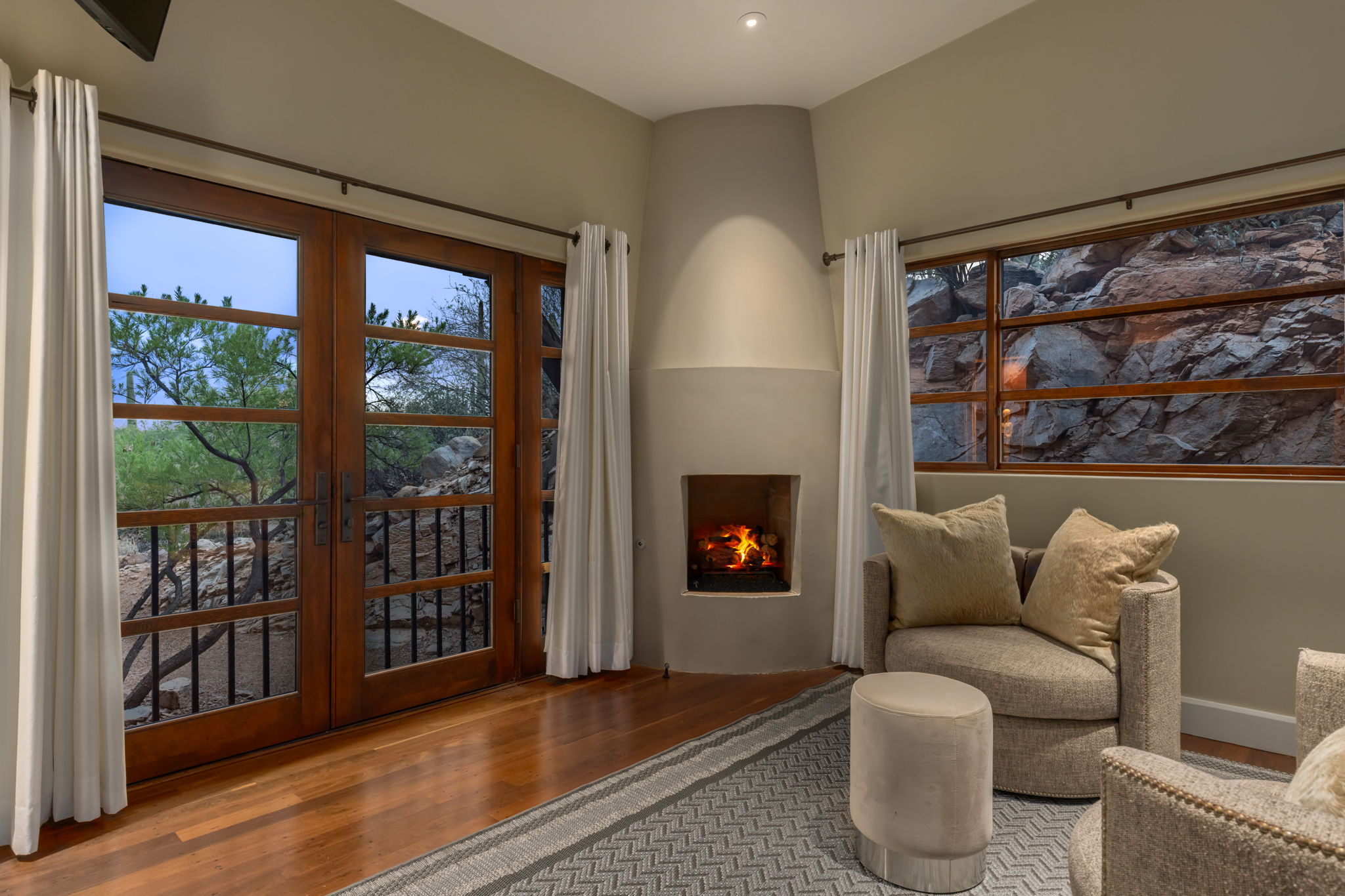 A sitting room within guest suite one, with a kiva fireplace