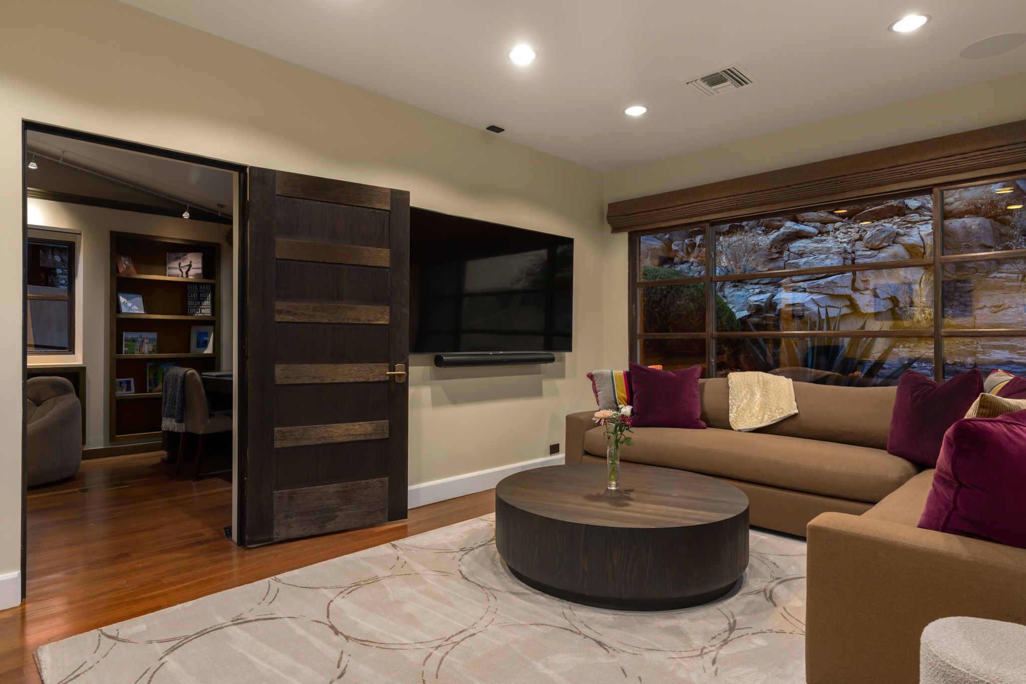 The office and media room with a wraparound sofa