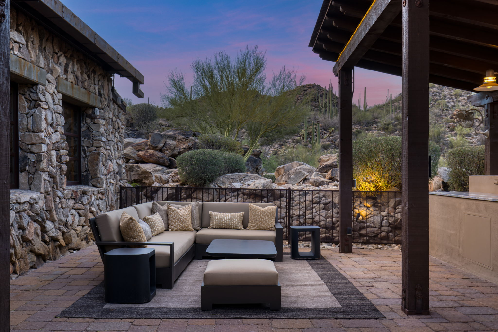 Outdoor sectional against the boulder garden at dusk