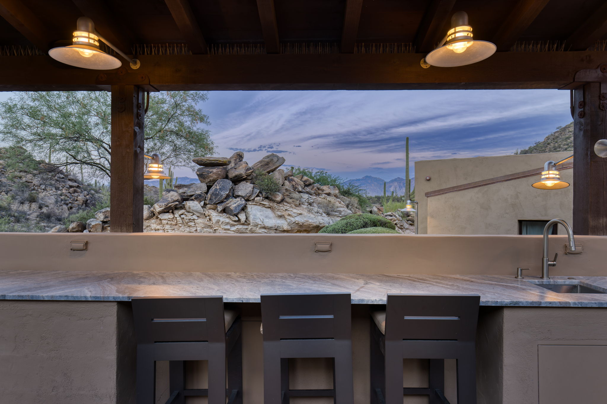 A screen rising from the stone counter with seating built around it