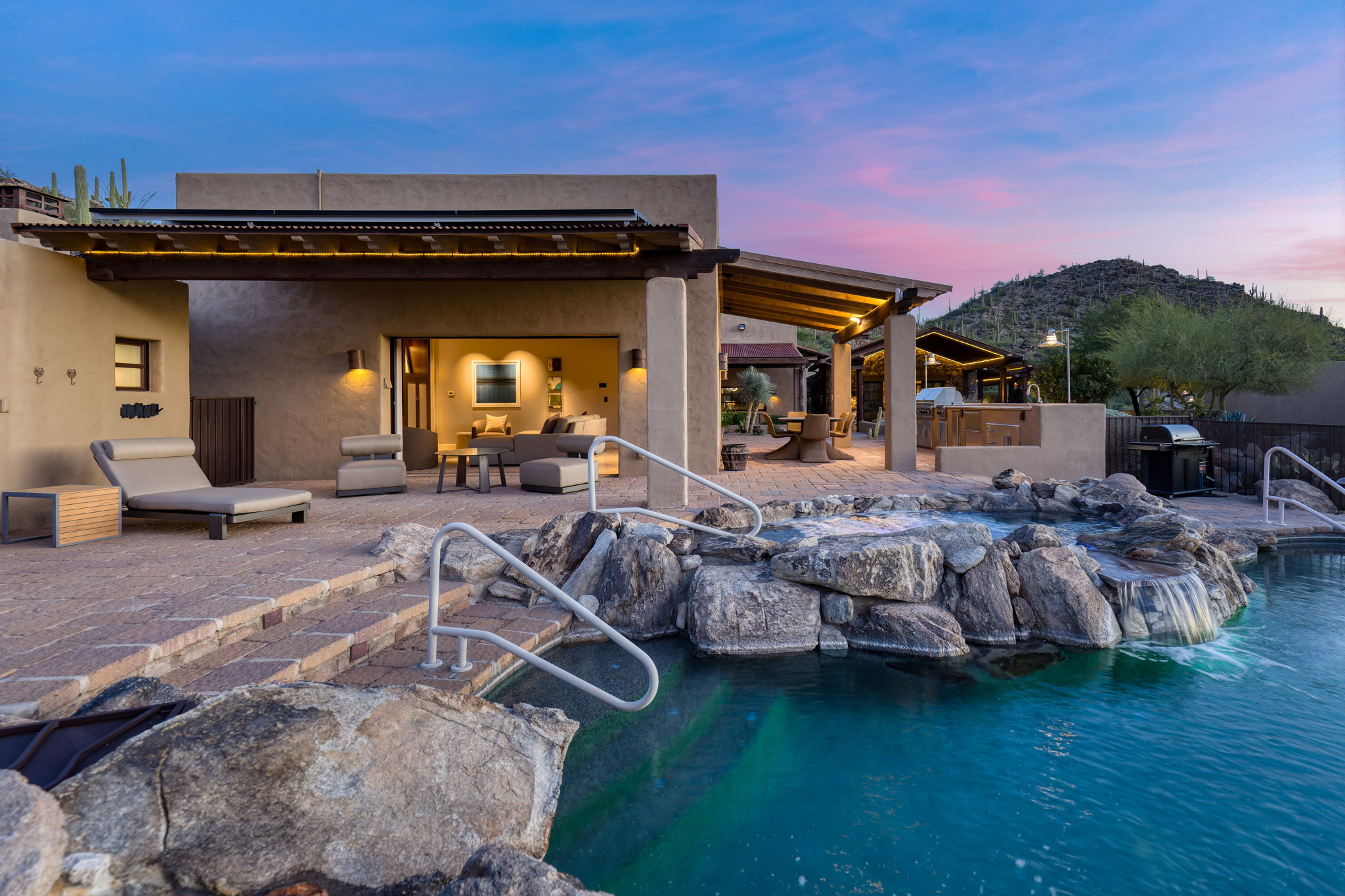 The pool blending into the natural desert at dusk