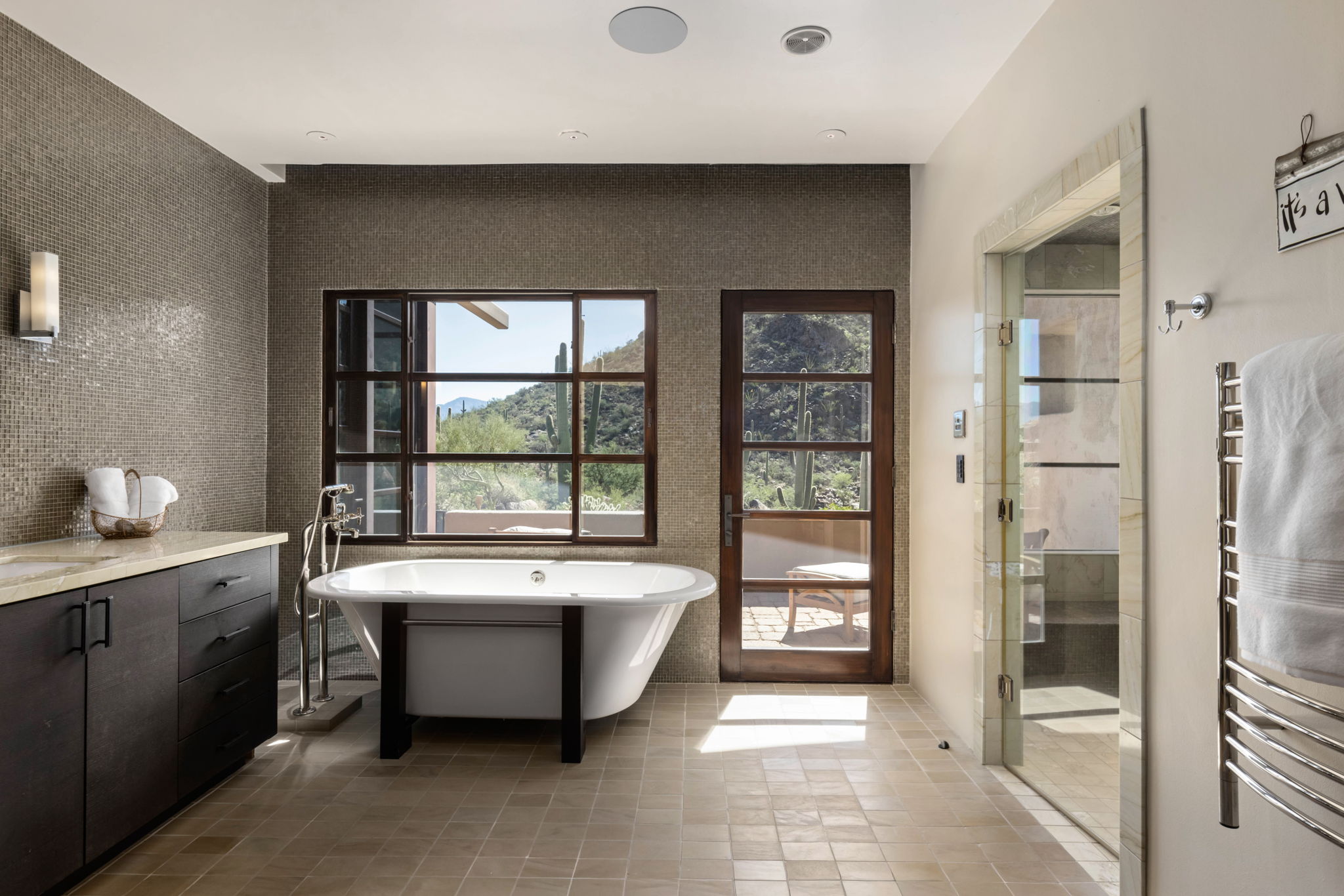 Freestanding tub at a window onto the saguaros